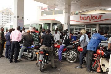 Motorcycle taxis queue to buy fuel at a Total filling station in Lagos on January 17, 2012. Many filling stations in Lagos and other parts of the country are short of supplies, with long lines for gasoline. Others are out of fuel entirely. (PIUS UTOMI EKPEI/AFP/Getty Images)